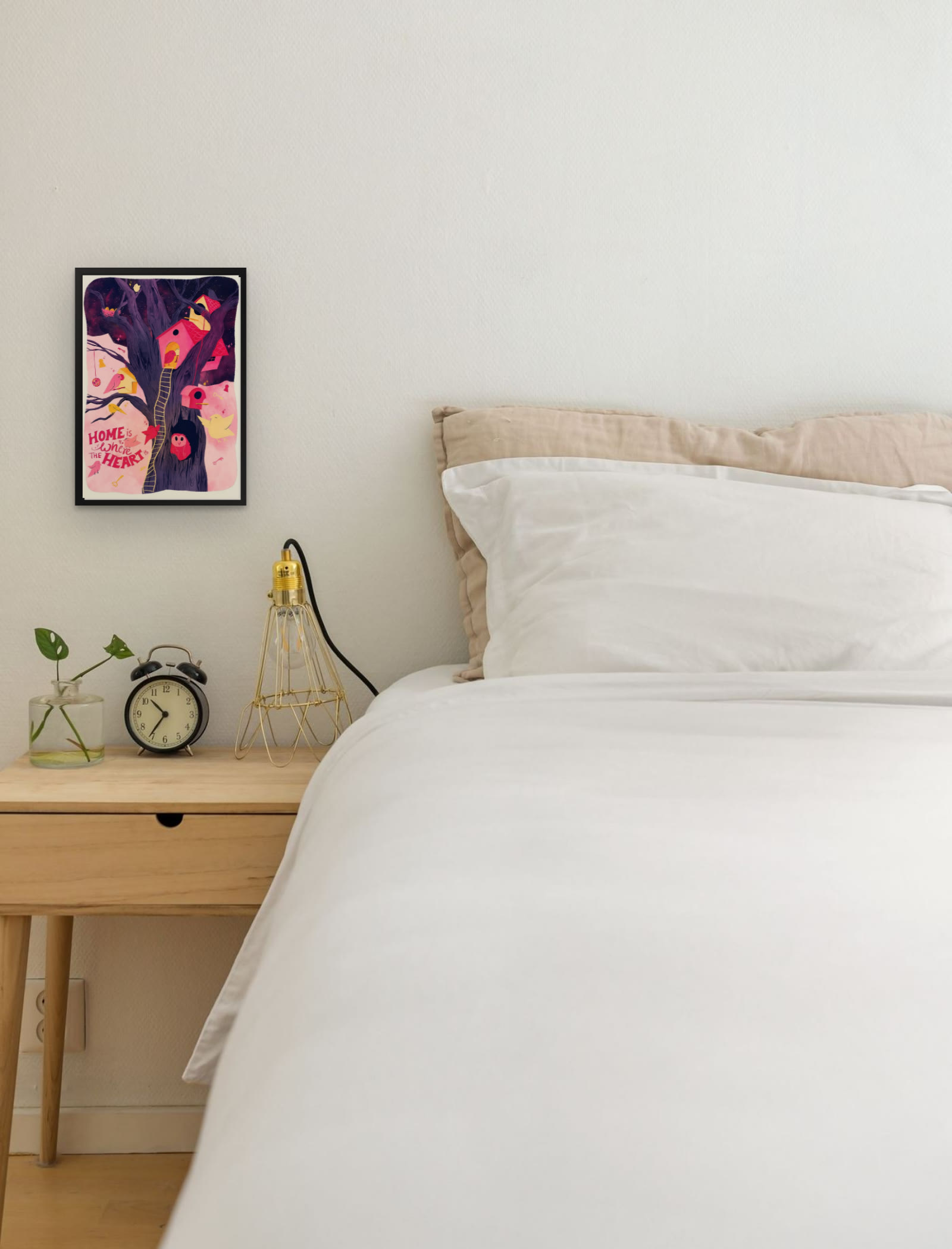 Home is Where the Heart Is, art print by Riya Kumari, framed beside a bed