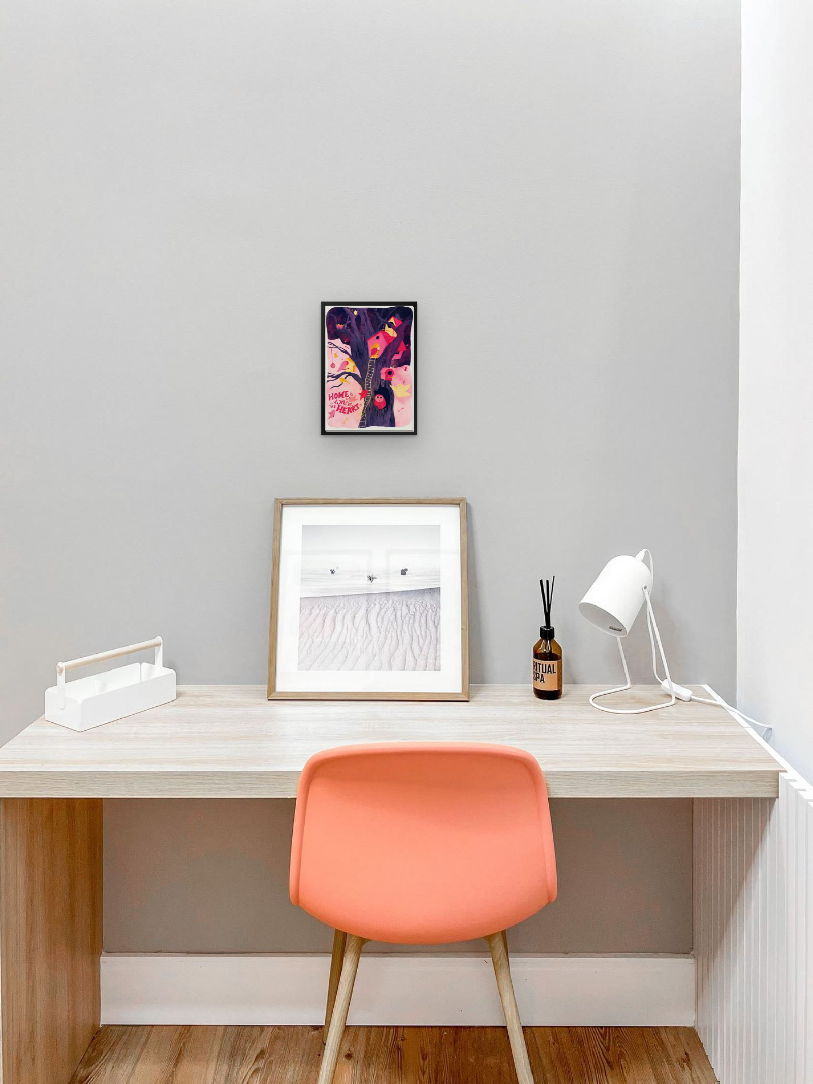 Home is Where the Heart Is, art print by Riya Kumari, framed above a desk
