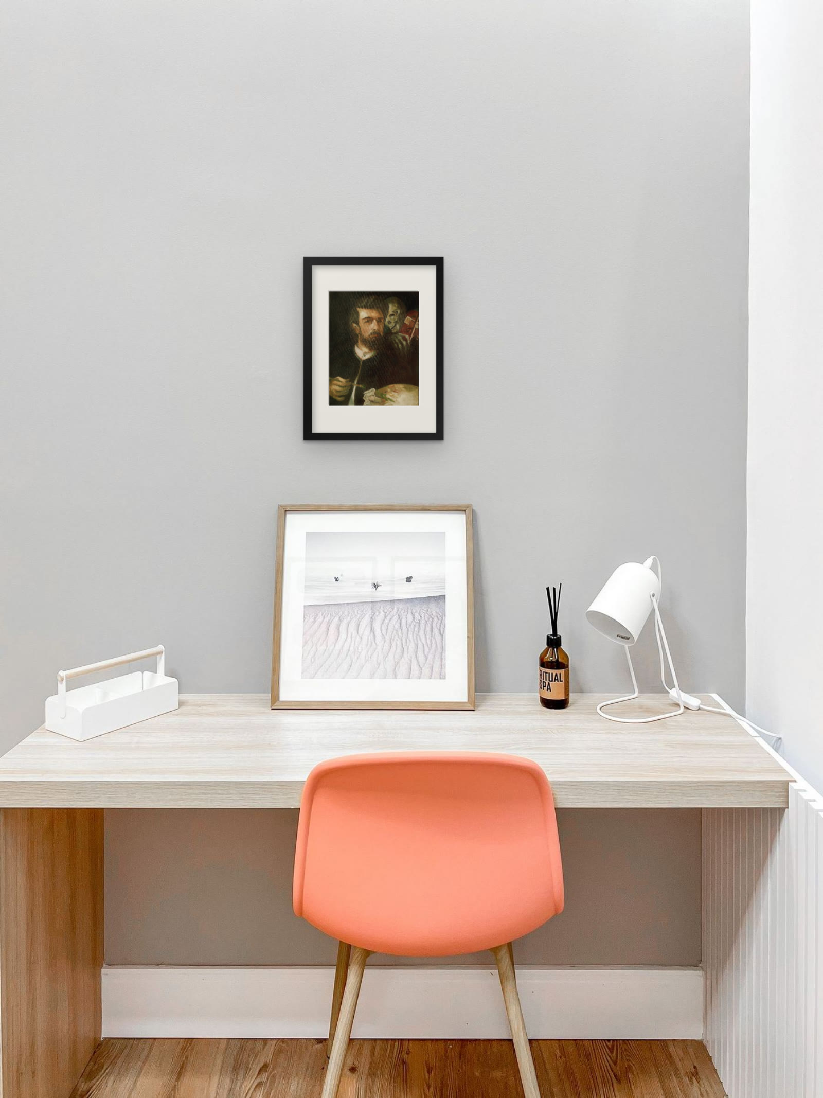 Self-Portrait with Death Playing the Fiddle, art print after Arnold Böcklin by Riya Kumari, framed above a desk