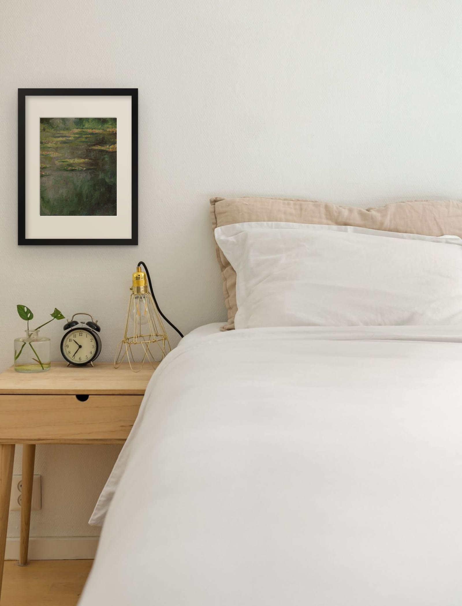 Water Lilies, art print after Claude Monet by Riya Kumari, framed beside a bed